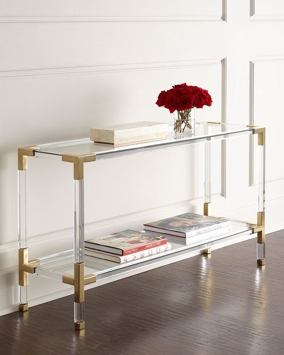 lucite and brass console looks fashionable and accomodates enough things