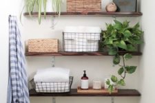20 thin dark stained wooden floating shelves for storing bathroom things