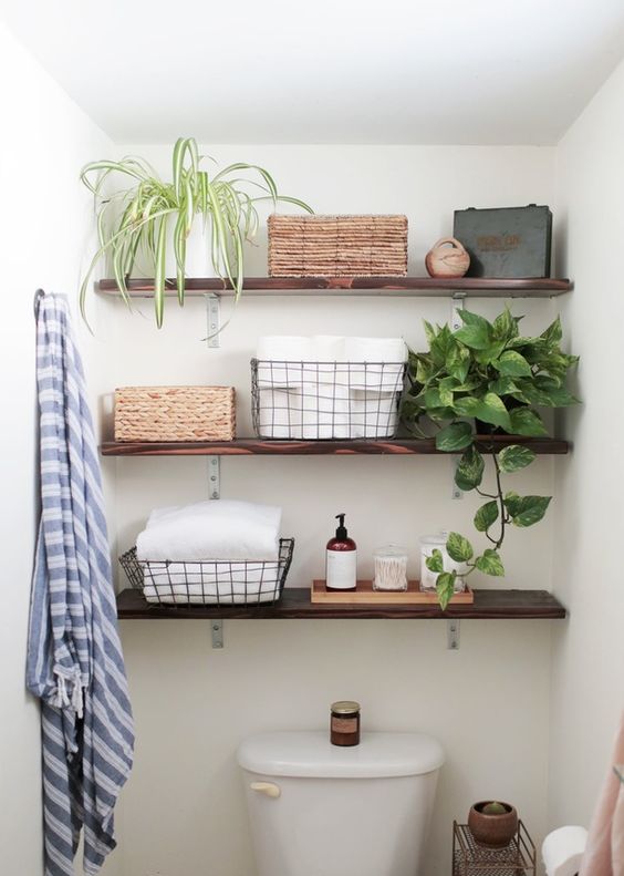 thin dark stained wooden floating shelves for storing bathroom things