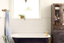 21 a black clawfoot tub and gold accents give the space an exquisite feel