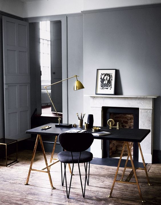 a brass and black lamp fits a mid-century modern manly office