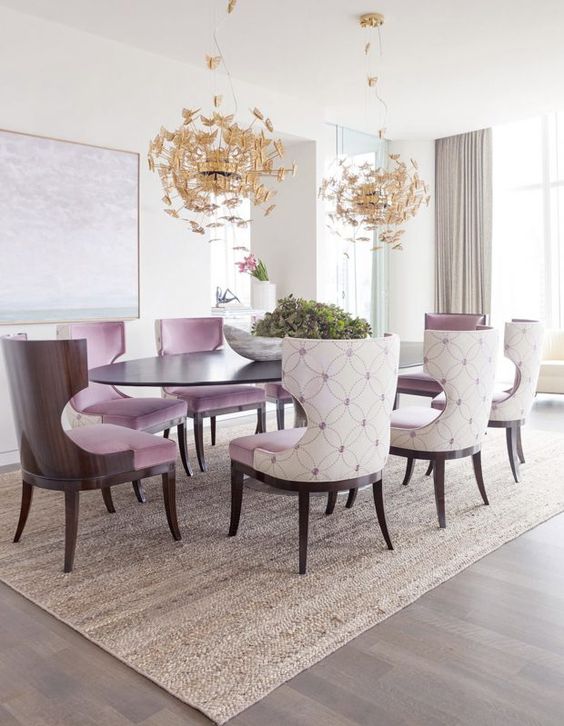 upholstered lavender chairs and gold butterfly chandeliers make the space girlish