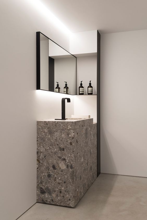 grey stone square sink with a black faucet for a moody bathroom