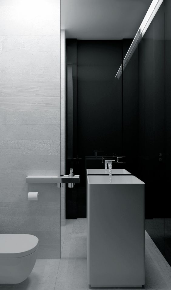 a minimalist black and white bathroom with a square sink