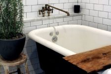 24 Scandinavian space with a black clawfoot tub and a black pot to pull it off