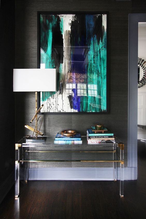 lucite and brass console table with a storage space looks almost invisible