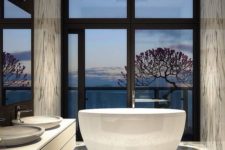 24 luxury bathroom with marble tiles and a gorgeous view from the tub