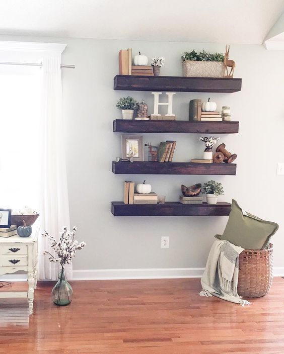 thick dark stained wood shelves make a statement in a light-colored space