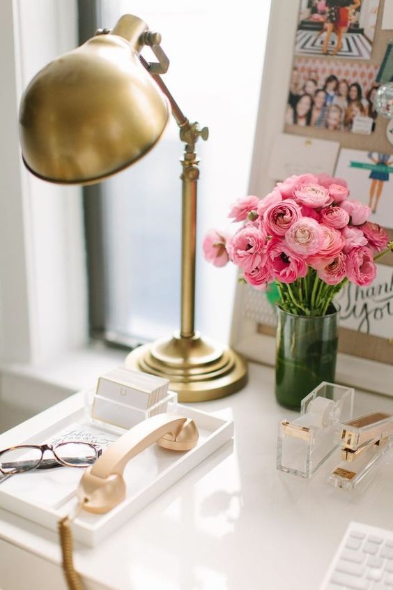 a brass vintage table lamp adds a glam feel to the workspace