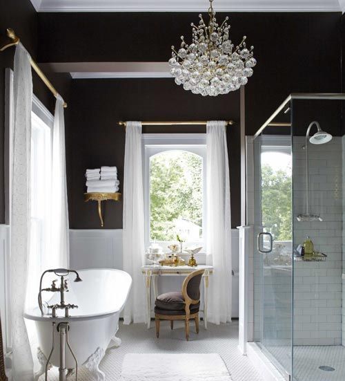 A vintage inspired bathroom with a modern glass bubble chandelier that catches an eye