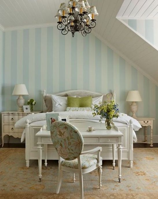 an elegant cottage bedroom with a shabby nightstand and a whitewashed sideboard
