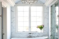 26 an oversized crystal chandelier in a modern bathroom makes it chic and more girlish