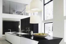 27 a white kitchen island with a geometric black countertop