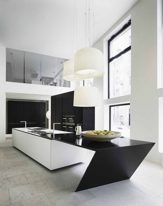 a white kitchen island with a geometric black countertop