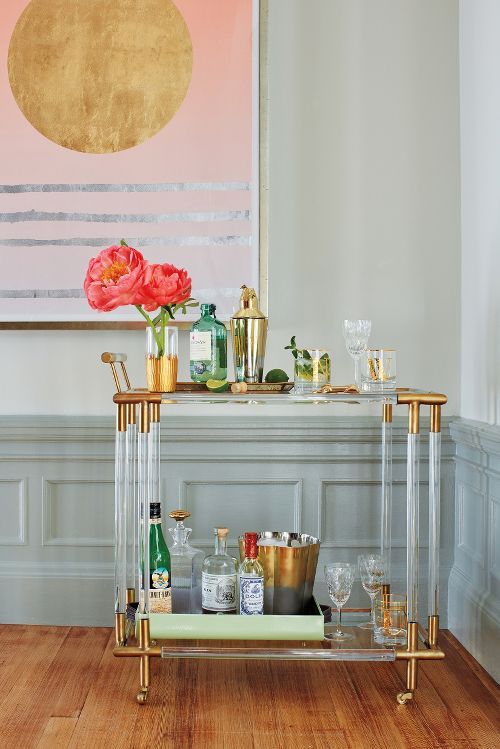 lucite bar cart with gilded elements looks super elegant