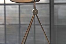 28 a comfy table lamp on three legs with a black concrete and metal lampshade