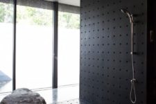 28 perforated metal shower with a real rock piece inside it