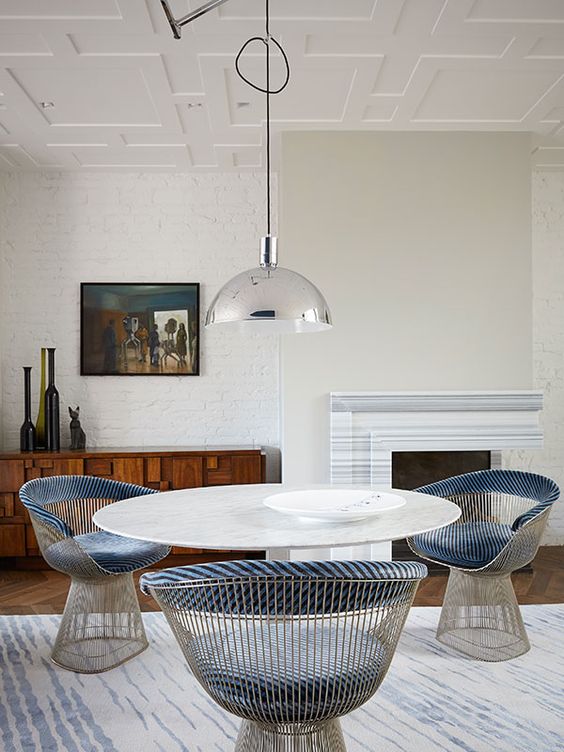 chic wire armchairs with blue upholstery are centerpieces here