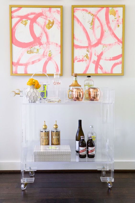 lucite bar cart on casters doesn't steal attention from the wall arts
