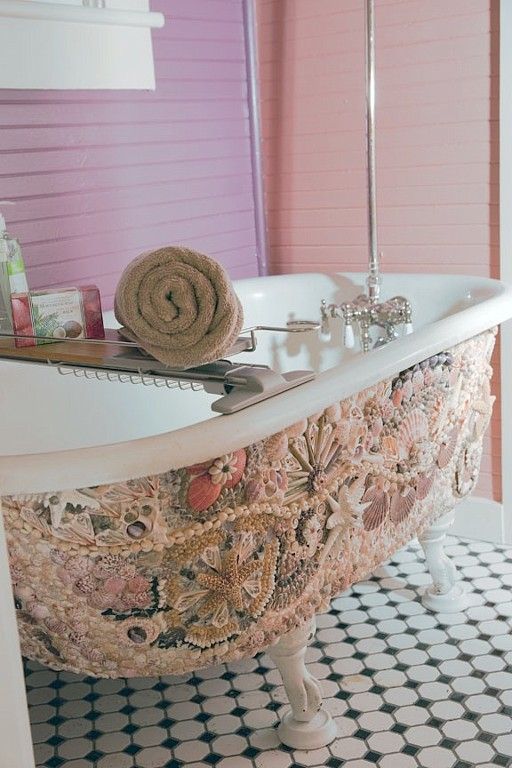 the beautiful shell mosaic on the tub screams beach and ocean
