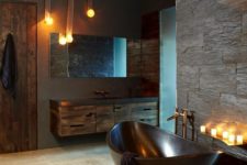 30 a masculine bathroom with a dark metal bathtub, which makes a statement