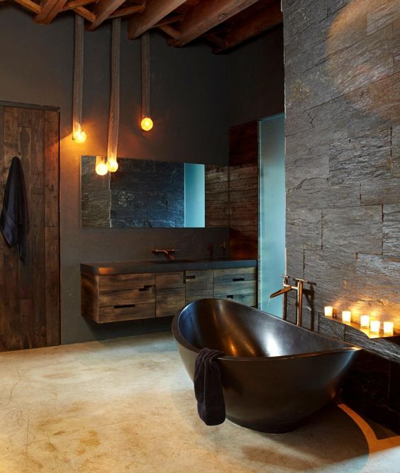 a masculine bathroom with a dark metal bathtub, which makes a statement