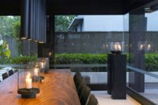 30 tube-like matte black pendants make the dining space manly