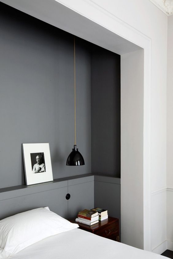 a mid-century modern black lamp looks great in a grey manly bedroom