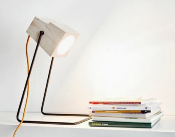 an industrial lamp made of metal legs and a white wood part