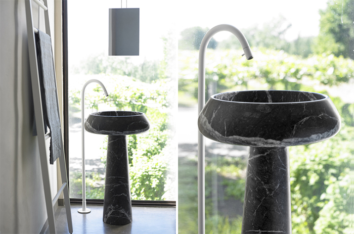 black marble free-standing sink is an elegant solution for a manly space