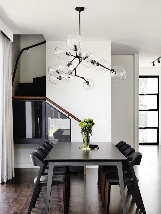 A modern chandelier with sheer glass shades and a geometric shape