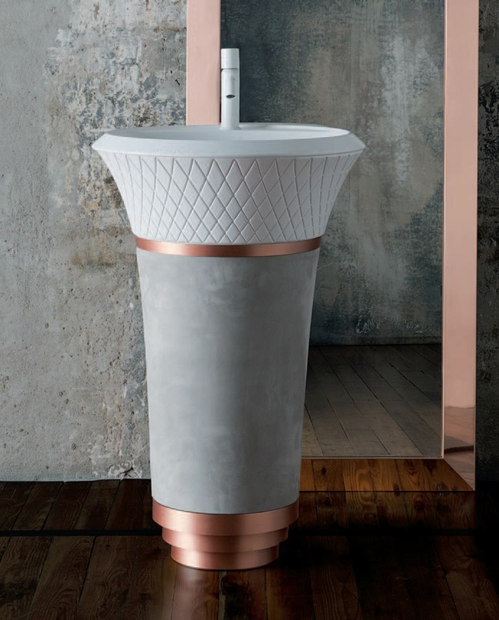 a concrete and copper free-standing sink with a pattern looks eye-catchy
