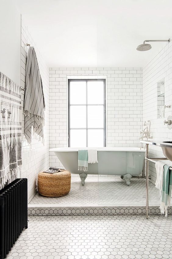 A mint bathtub in the shower area of a retro inspired bathroom