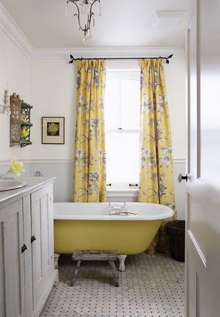 a sunny yellow bathtub and floral curtains for a shiny bathroom