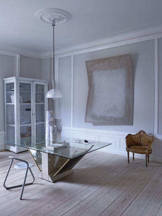 This pale and peaceful apartment is located in a 1734 building, and its historical elements were preserved by the designer