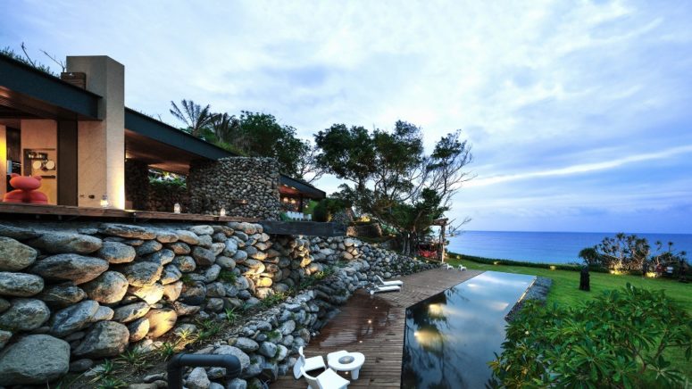 This stunning house is covered with stone that was excavated from its site and it faces the Pacific Ocean