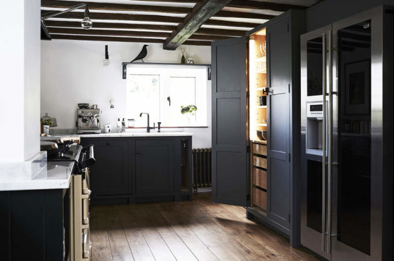 The cabinets are graphite grey with a white marble top, there's a built-in pantry for more storage