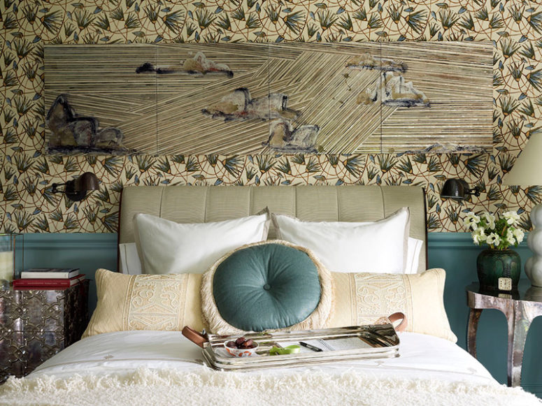 The graphic floral wallpaper coveres the walls and there's wainscoting in the same blue shade