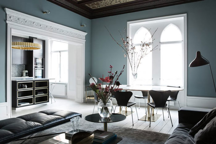 The grey blue walls are combines with whitewashed floors and vaulted ceilings for a unique look and an airy feel