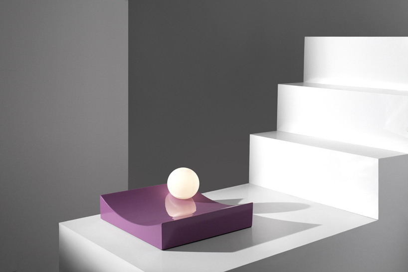 the lights appear to be rolling down sculptural geometric plinths