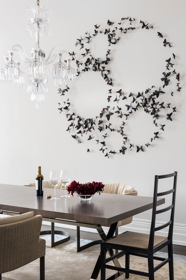The dining area features a stunning butterfly installation on the wall