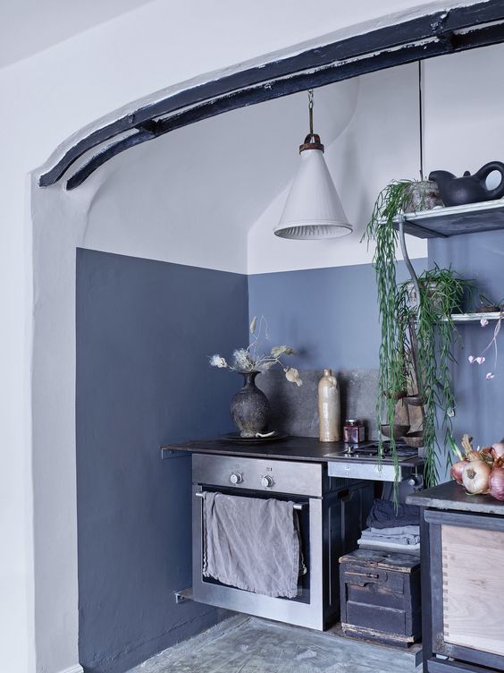 The kitchen is accentuated with asphalt grey, there's vintage furniture and appliances, and lamps are mid century modern