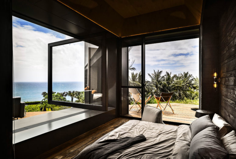 The master bedroom is all about adorable views, there's a glazed door and a glazed wall that can be opened outdoors