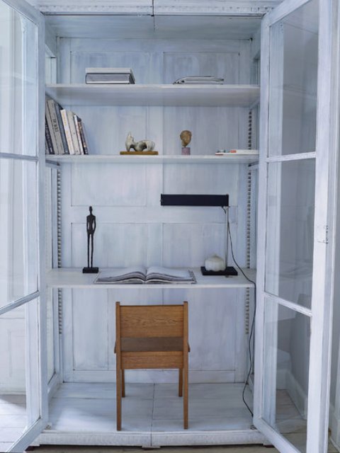 The closet was turned into a small home office with whitewashed walls, doors and shelves, such a cool solution