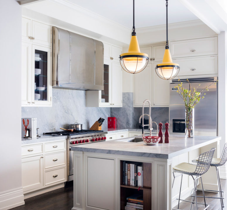 The kitchen is done in cream and grey marble, which create a cozy and chic ambience