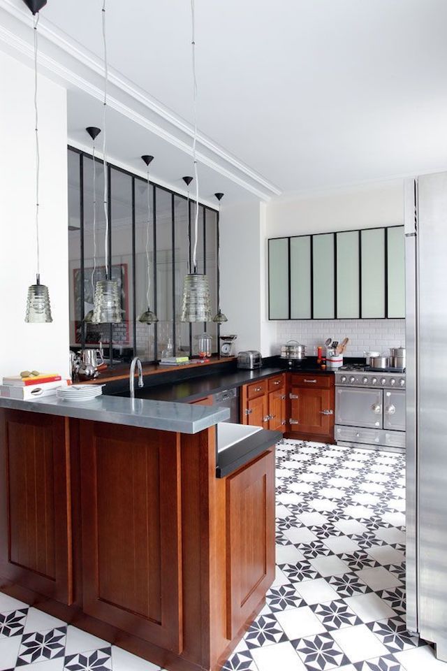 The kitchen is eclectic with warm colored cabinets and stainless steel appliances
