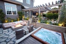 06 an outdoor living room with a fire pit and a jacuzzi on a wooden deck