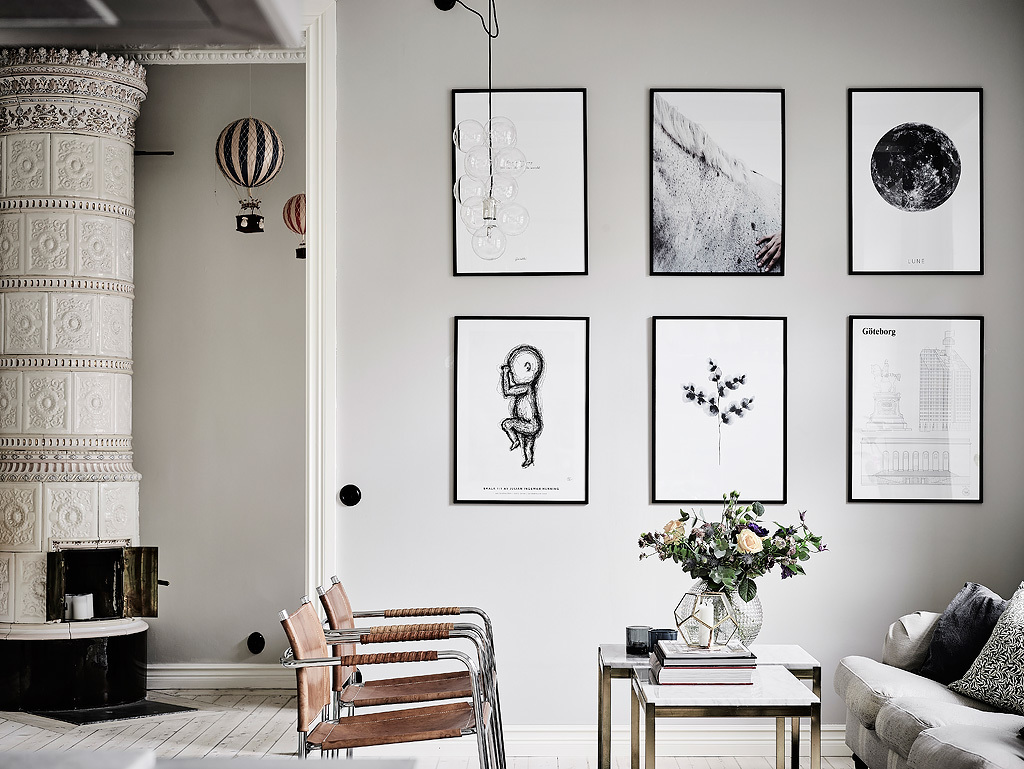 Brown leather chairs and black and white artworks add eye catchiness to the space