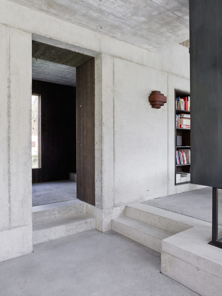 The combo of rough concrete and dark wood looks very textural and eye-catching