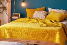 07 a navy statement wall contrasts with sunny yellow bedding